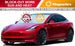 Red car with Magnelex sunshade on windshield, featuring text about blocking sun and heat.