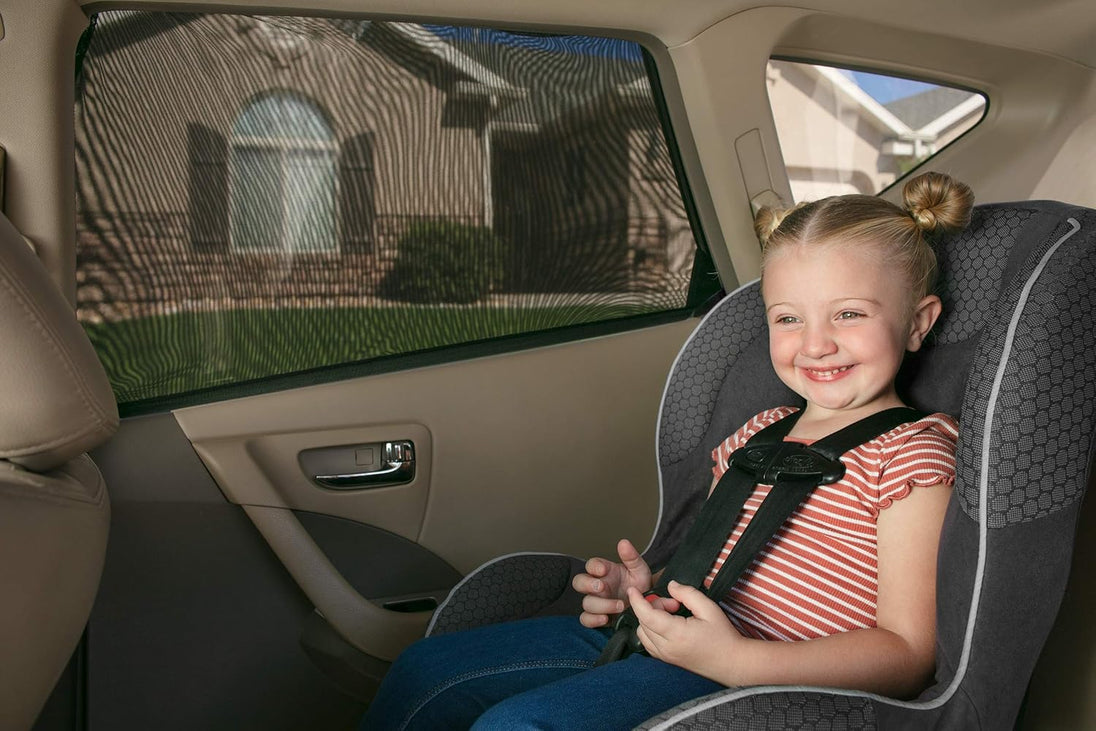 Child in a car seat with a window shade in a vehicle