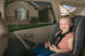 Child in a car seat with a window shade in a vehicle