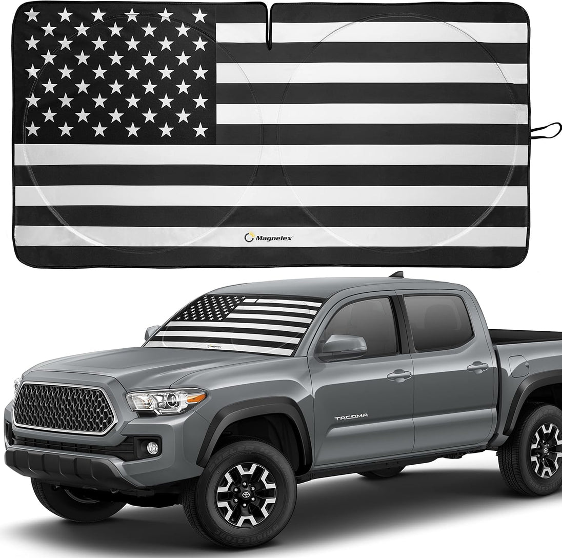 Black and white American flag windshield sunshade shown on a Toyota Tacoma pickup.