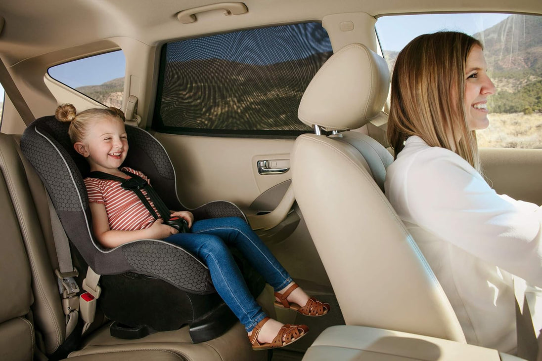 Mesh car side window sunshade providing UV protection for a child in a car seat, reducing glare and heat inside the vehicle.