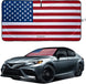 Car sunshade with American flag design and a car featuring an American flag decal on a white background.